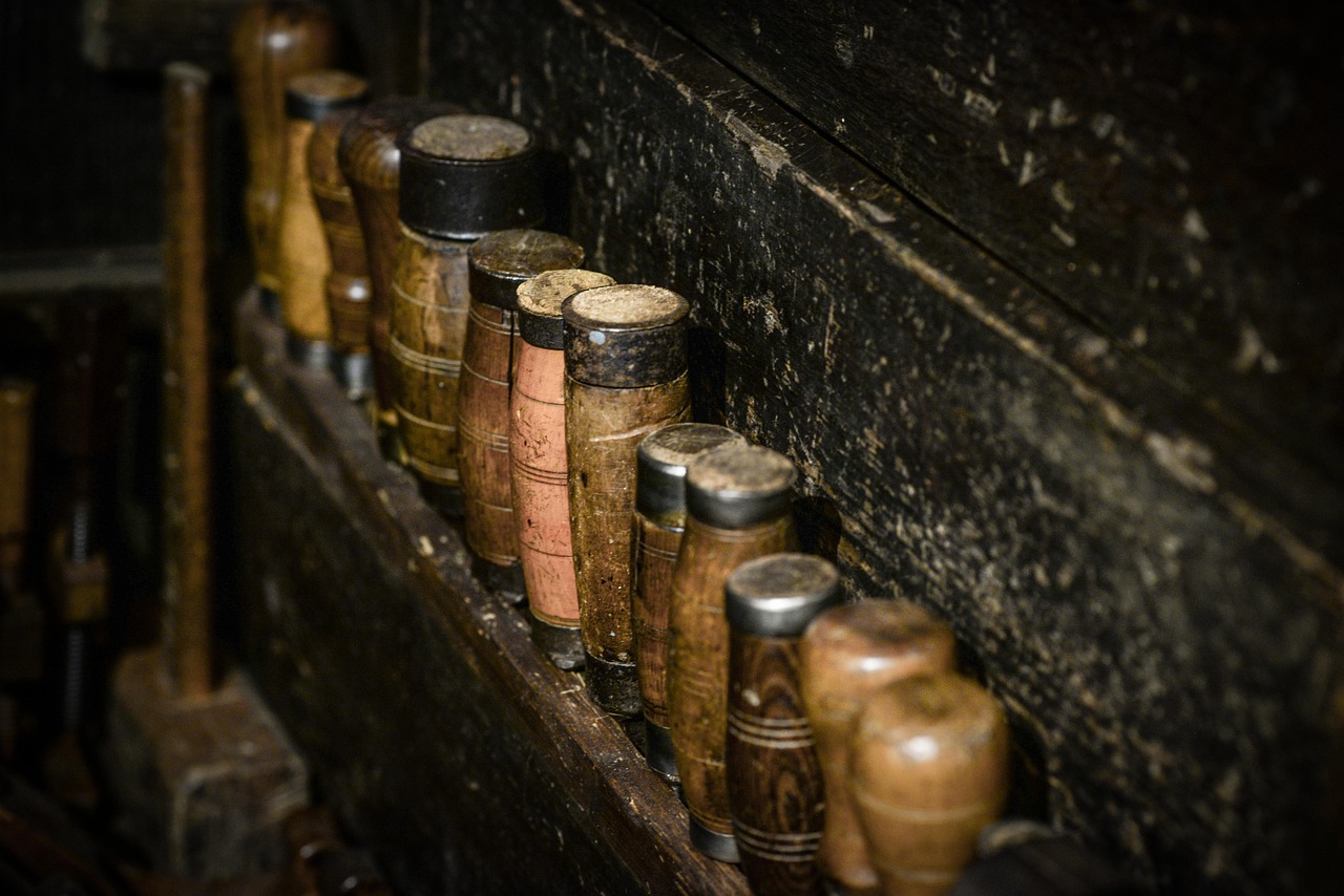 A row of sharpened chisels lined up on the bench, edges catching the light